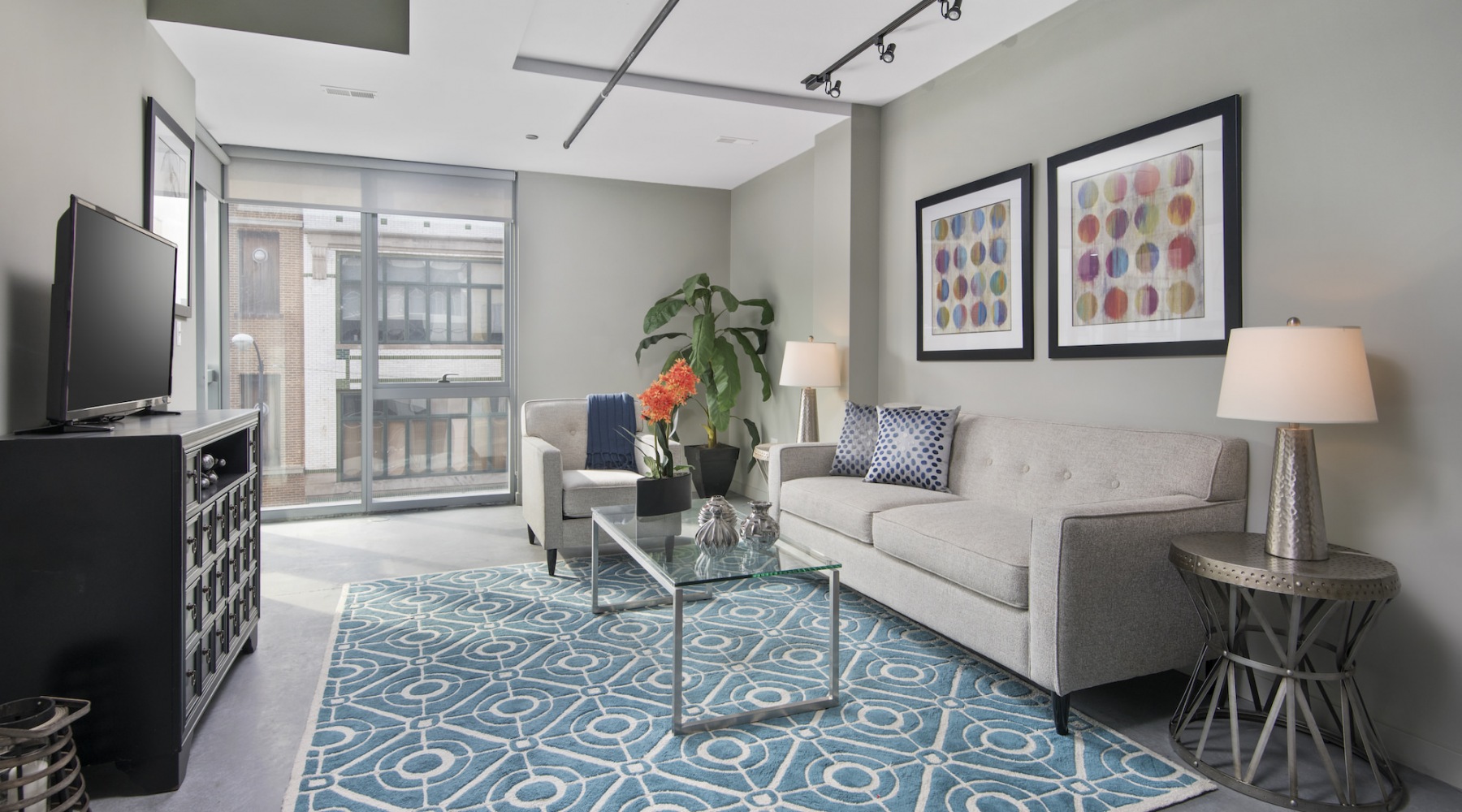 Living room with a couch and large windows