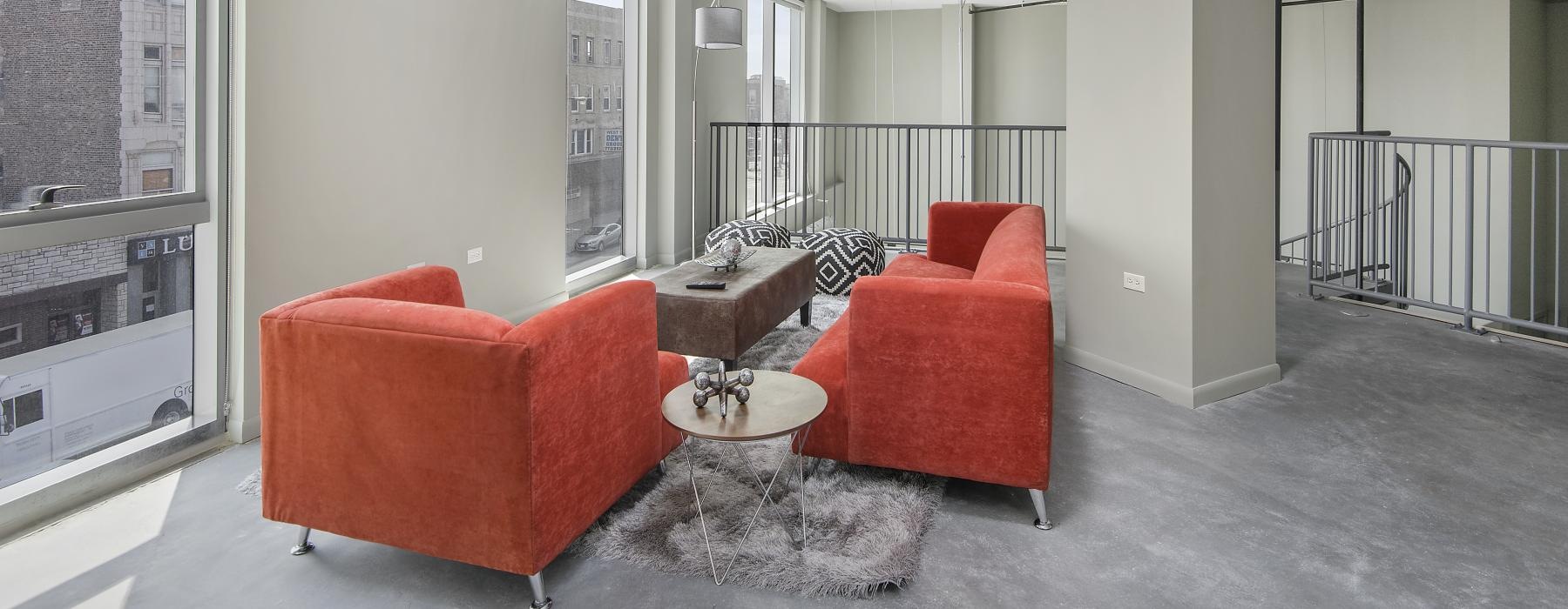 a living room with red chairs
