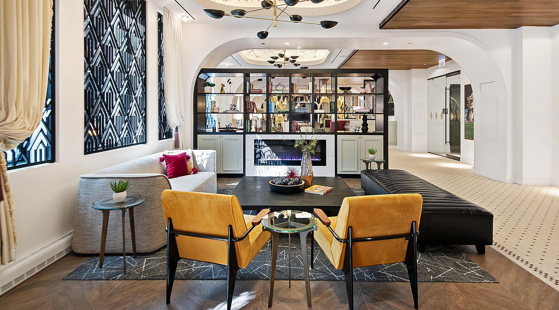 Resident clubhouse with ample seating, fireplace, demo kitchen and TVs