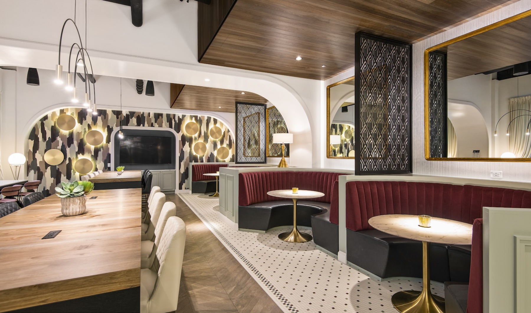 Resident clubhouse with ample seating, fireplace, demo kitchen and TVs